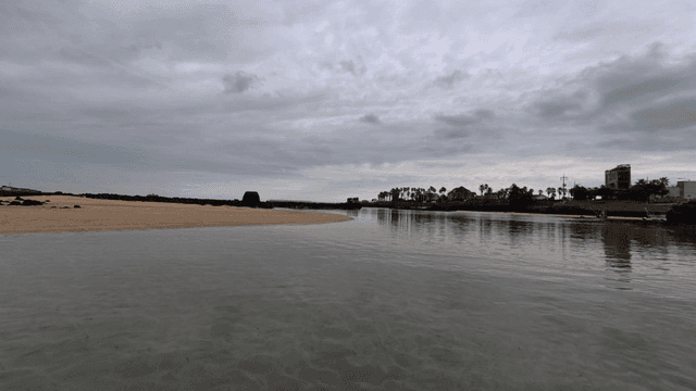 Quiet beach under cloudy sky