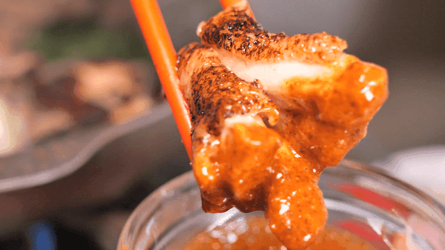 Grilled chicken dipped in sauce
