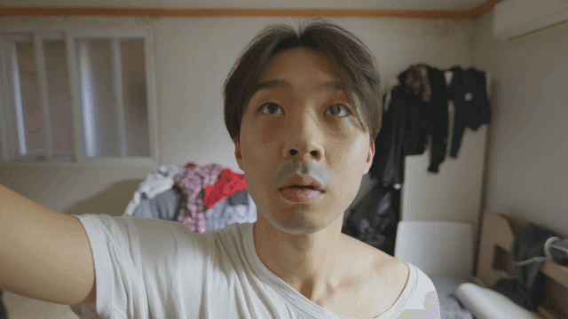 Man catching a bug in a messy room