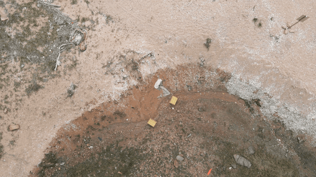 Aerial view of a barren landscape with scattered debris
