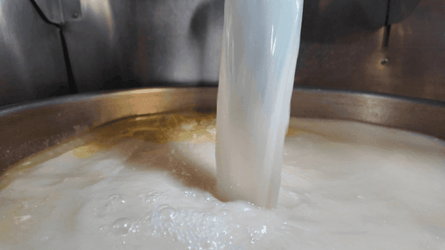 Clear beef bone broth poured into pot