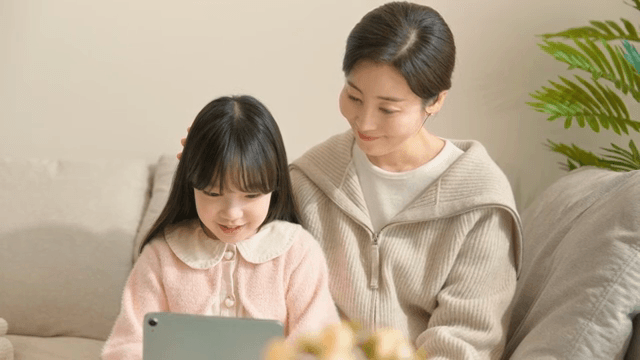 Mother and daughter looking at a tablet together