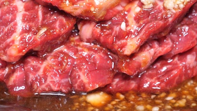 Marinated Beef Slices Being Cooked on a Grill