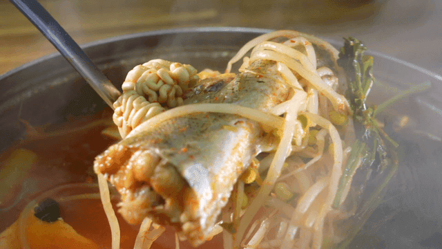 Spicy fish stew with vegetables boiling