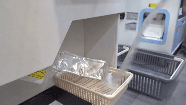Medicine packets being dispensed into a basket