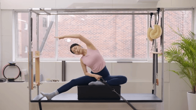 Woman exercising on a cadillac