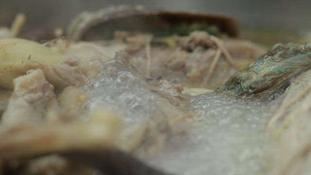 Samgyetang made with abalone and chicken boiling in a pot