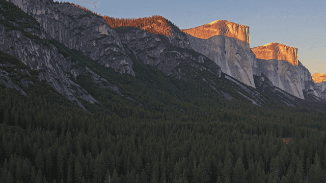 Sunlit mountains and dense forest