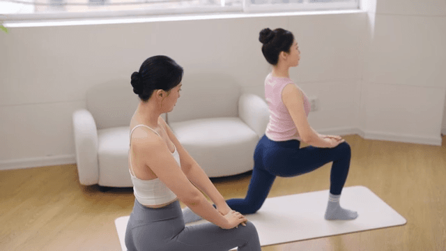 Two women practicing yoga indoors