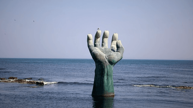 Large hand sculpture in the sea