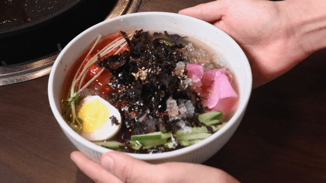 Bowl of cold noodles served on table