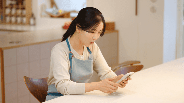 Woman using smartphone at table