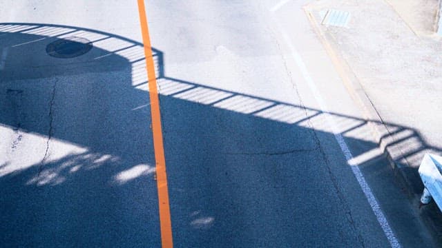 Gray Driveway with Shadows of Overpass stairs