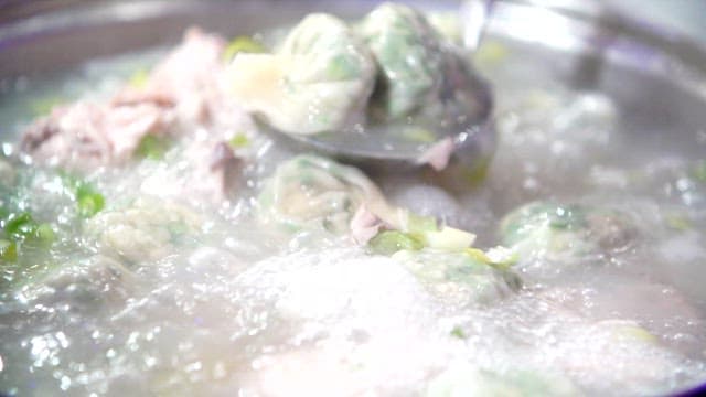 Dumplings boiling in a chicken soup