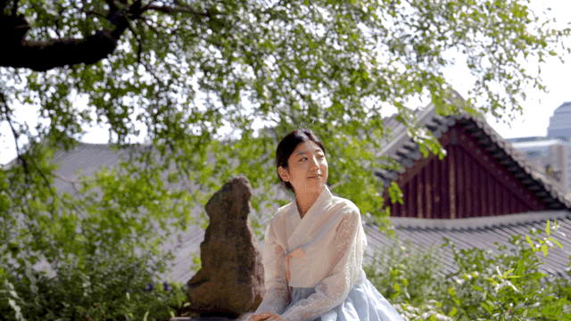 Woman in hanbok in a traditional garden