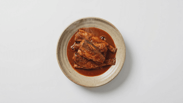 Braised mackerel in spicy sauce on a plate