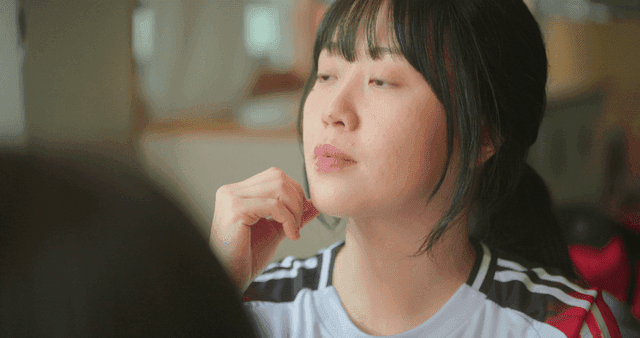 Schoolgirl in gym clothes feeling slightly hurt in a classroom