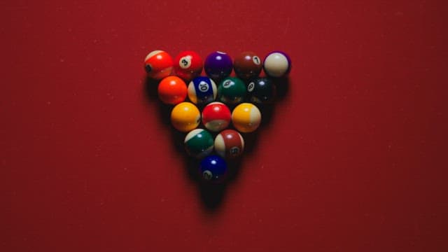 Red Pool Table with Colorful Billiard Balls on it