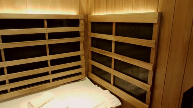 Inside a Well-lit Wooden Sauna with a Towel