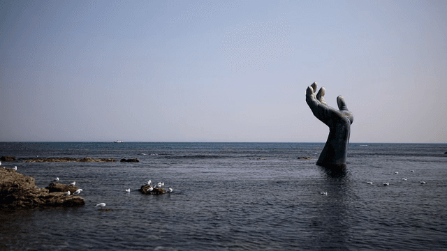 Large hand sculpture in the sea