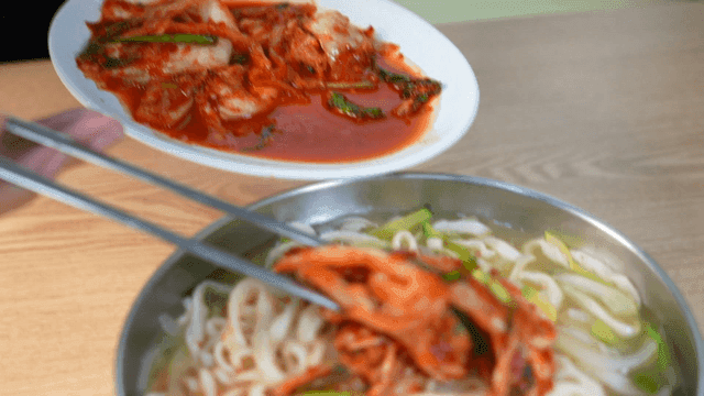 Hand-cut noodles topped with kimchi