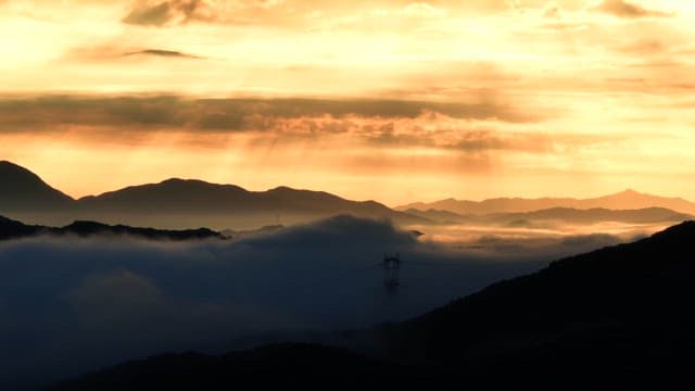 Sunrise over misty mountains