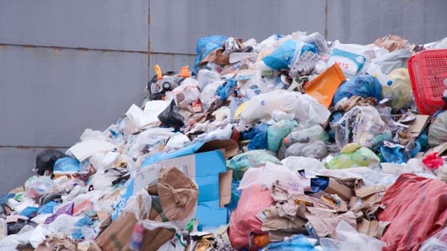 Large piles of garbage at a recycling facility