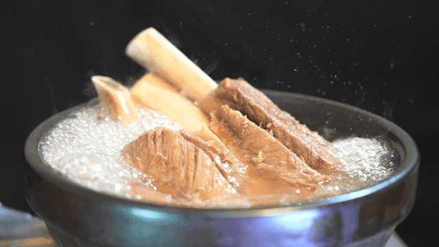 Beef bone galbitang broth boiling in pot