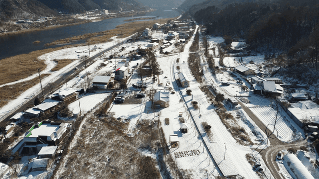 Snow-covered village by a river
