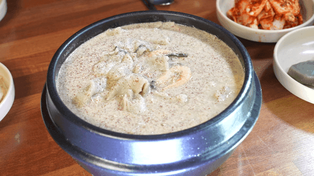 Perilla leaf dumplings and side dishes on table