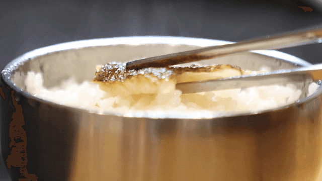 Steamed rice with grilled fish on top