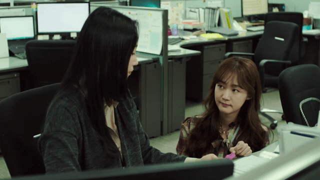 Office workers discussing at their desks