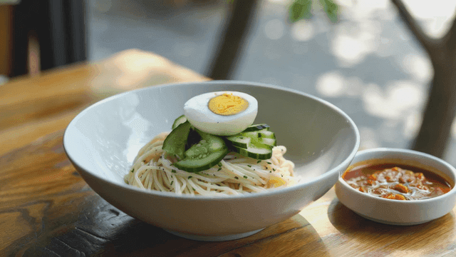 Noodles topped with cucumber and egg