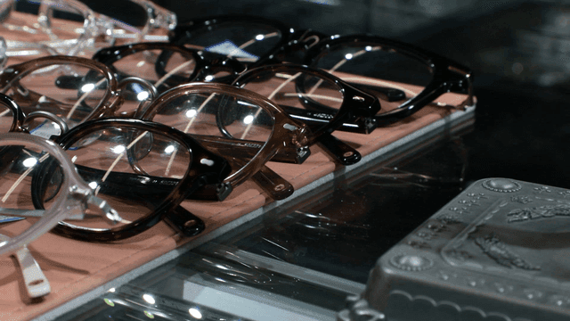 Various eyeglasses displayed on a shelf