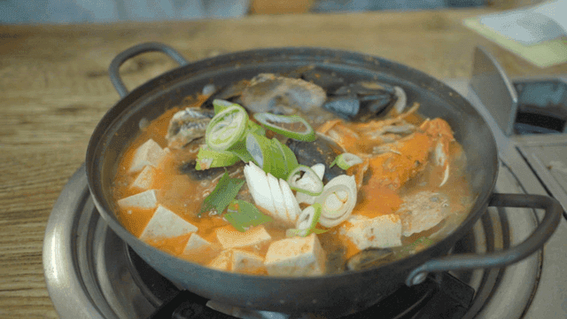 Korean seafood stew boiling in a pot