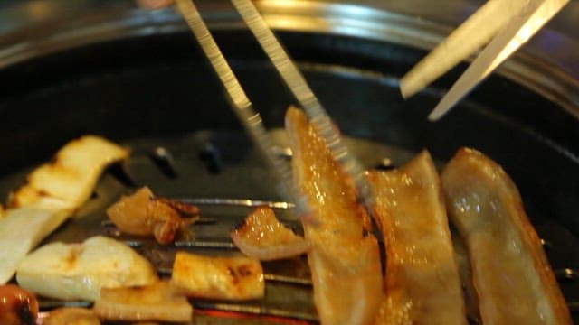 Cooked pork rinds cutting with scissors