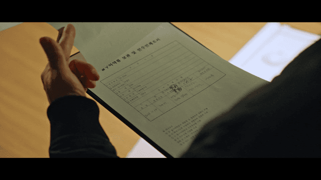 Person reviewing drug-related documents on clipboard