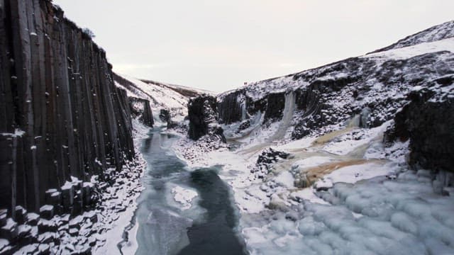 Snow-covered canyon with a frozen river
