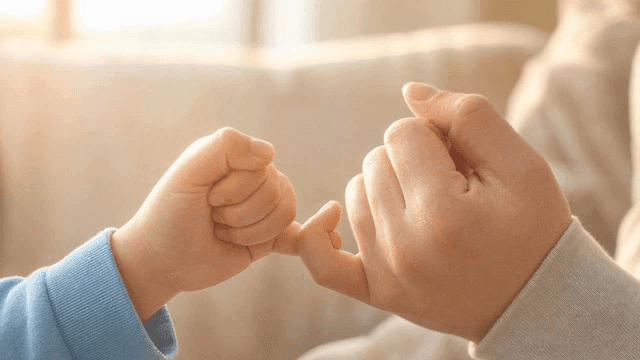 Image of child's hand making promise