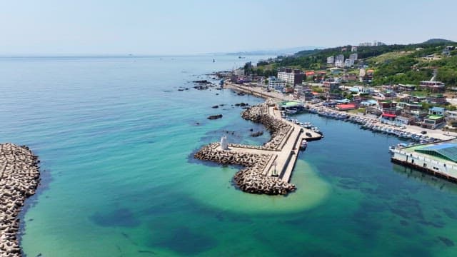 Coastal village with a breakwater and lighthouse