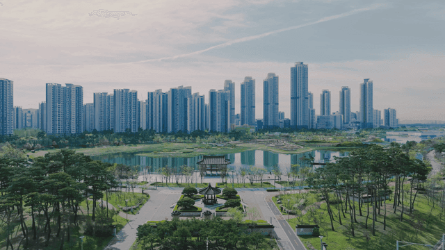 Modern city skyline with park and lake
