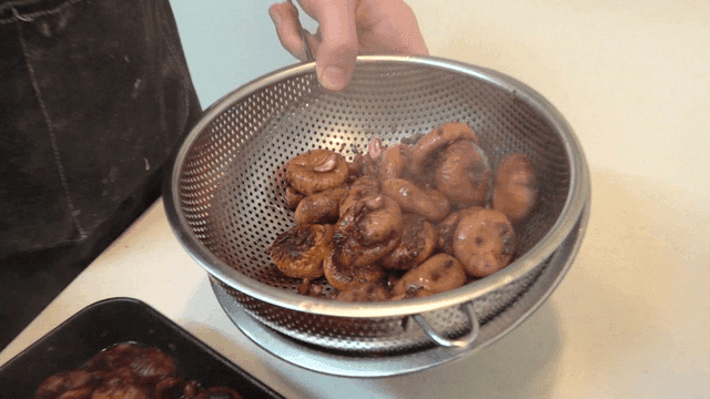 Being strained through a kitchen sieve figs