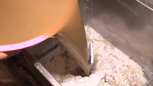 밀가루가 든 기계에 도토리물을 붓는 장면