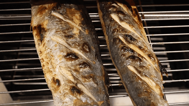 Grilled Spanish mackerel on metal grill