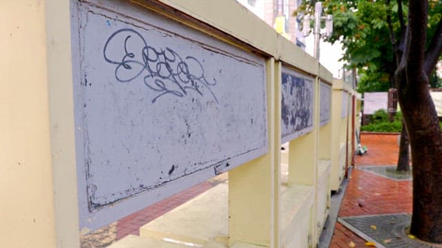 Graffiti on a yellow barrier in a park