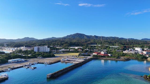 Coastal town with mountains and clear sea