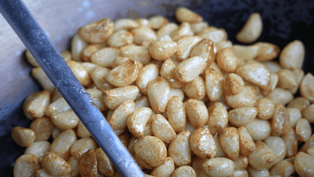 Garlic being sautéed in a pan