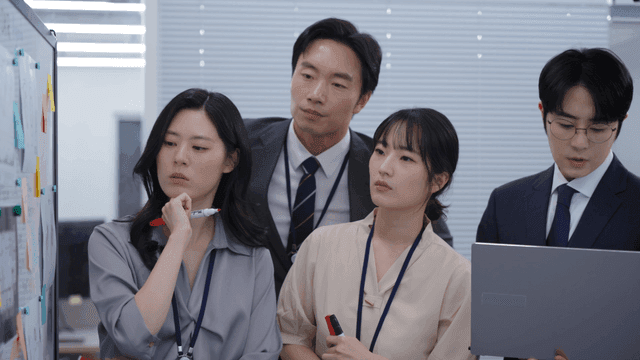 Colleagues discussing ideas at a board