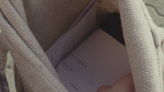 가방 안을 뒤지며 물건을 찾는 사람