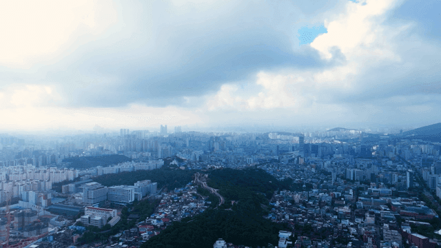 Sprawling cityscape under cloudy skies